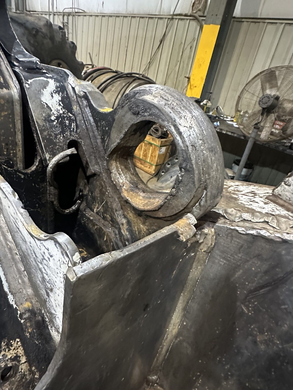 Worn heavy equipment pivot bore before repair