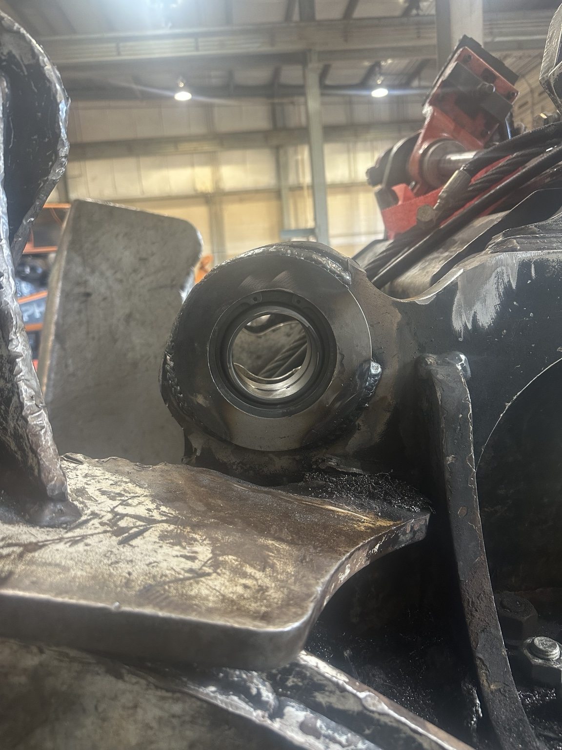 Repaired heavy equipment pin bore