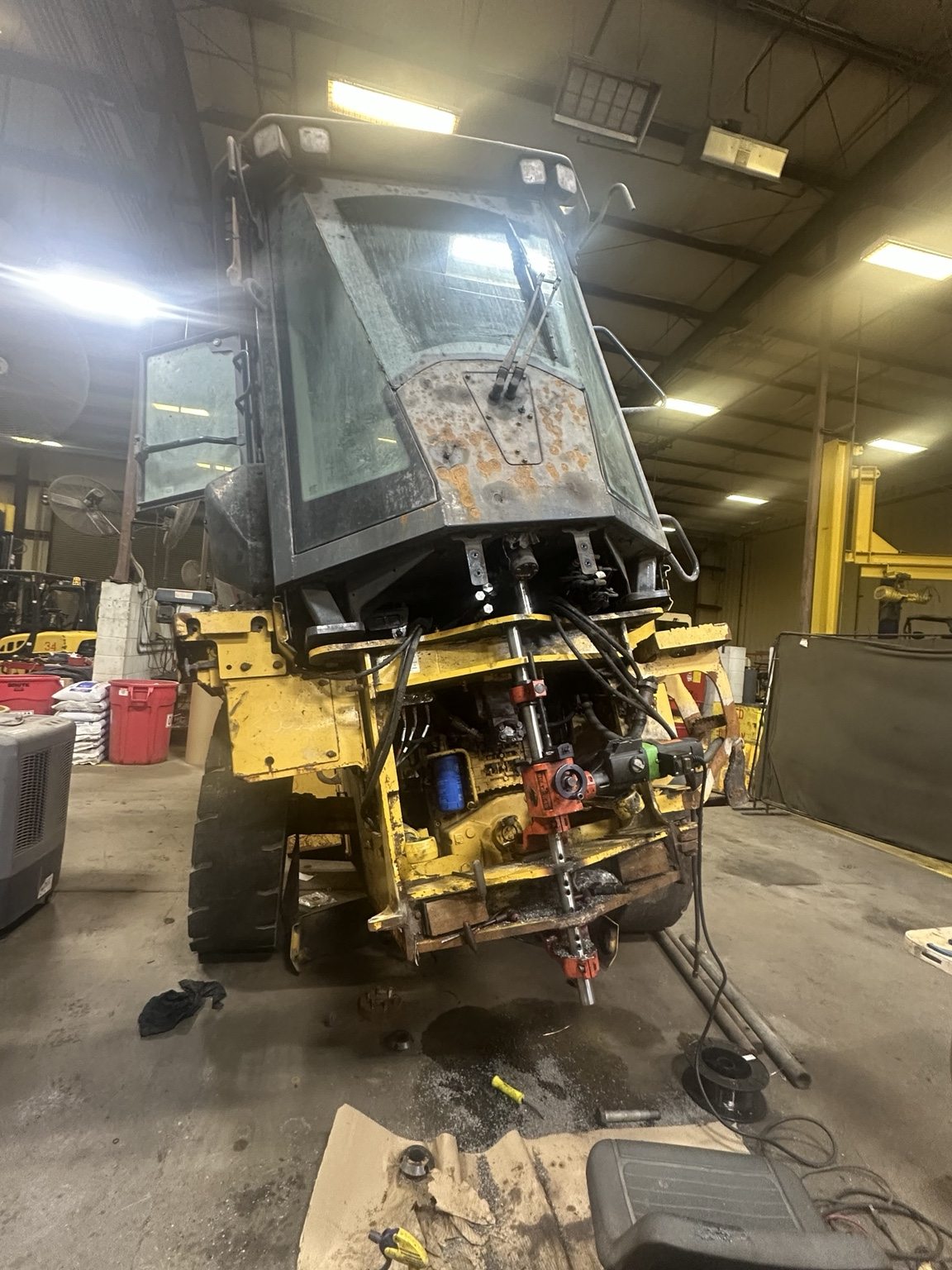 Heavy equipment undergoing shop repairs